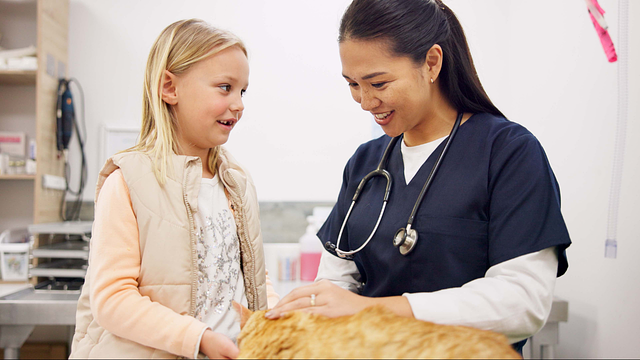 Veterinarian and young client with pet